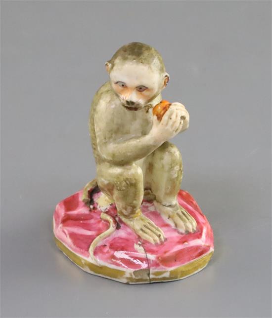 A Rockingham porcelain figure of a seated monkey, c.1830, H. 7.1cm, repaired